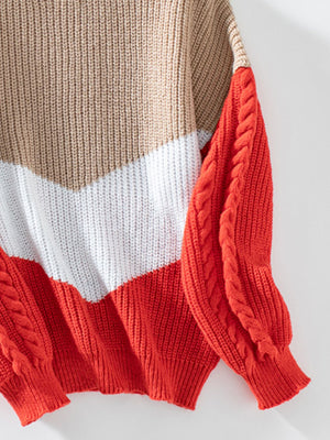 Chevron colorblock cable knit sweater in tan, white, and orange-red with braided sleeves.