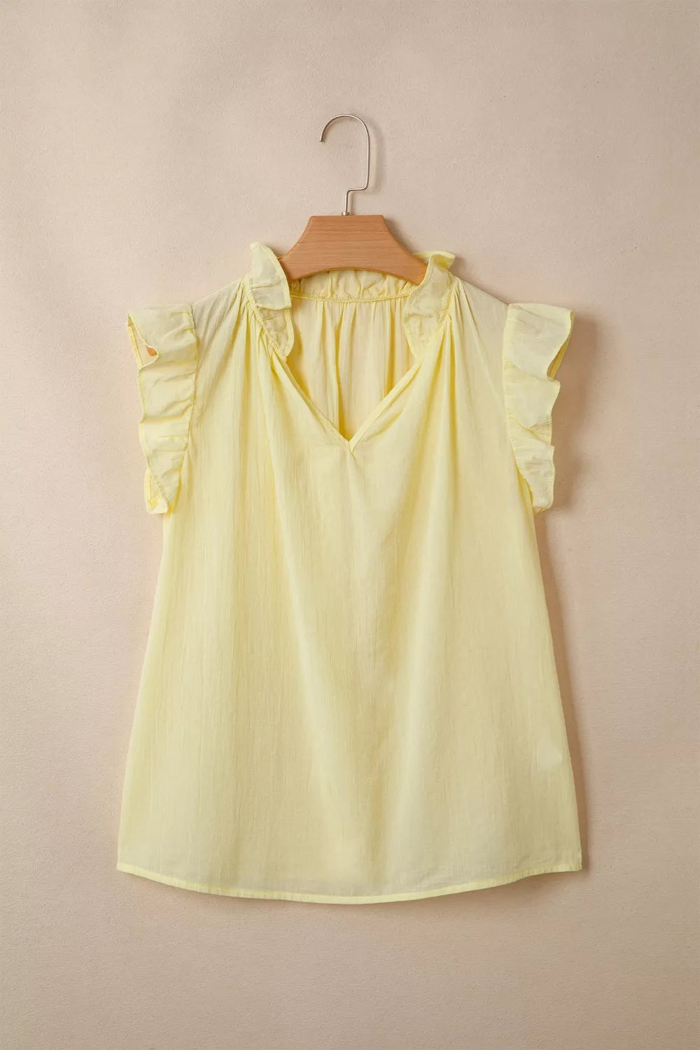 Yellow cotton blend V-neck shirt with ruffled cap sleeves and neckline