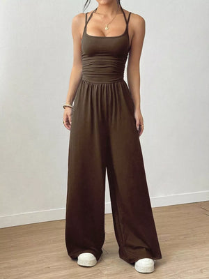 Coffee brown wide-leg jumpsuit with ruched bodice and spaghetti straps.