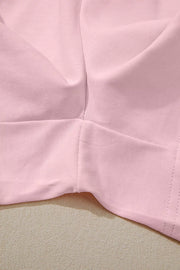 Blush pink pajama shorts set detail showing fabric texture and seams.