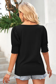 Black puffed sleeve cuff detail top with button accents