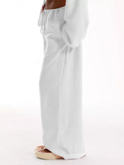 White relaxed wide-leg maternity pants with drawstring waist and pockets.