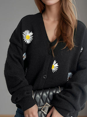 Black oversized knit cardigan with daisy embroidery and button front.