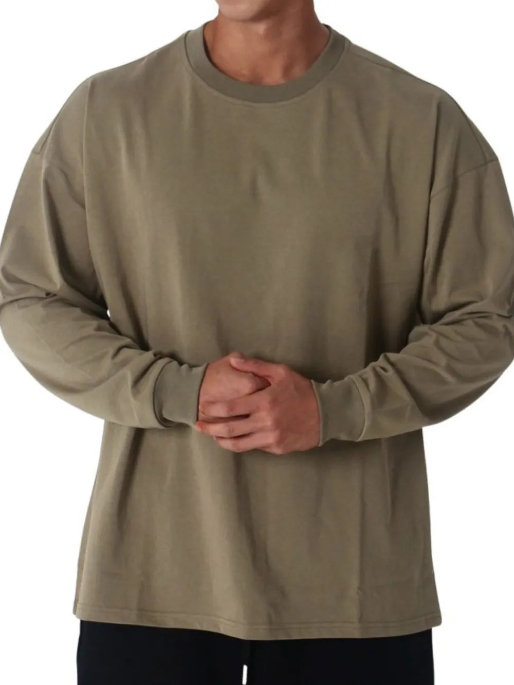Oversized crewneck long sleeve tee in olive washed cotton with relaxed fit.