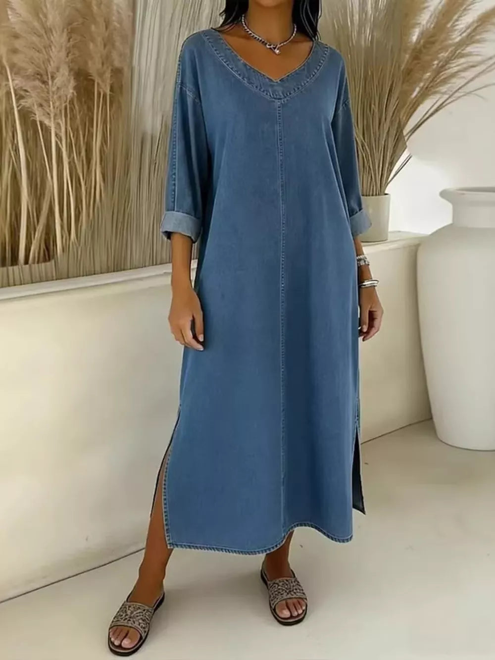 Light blue denim midi dress with V-neck, long sleeves, and side slit.