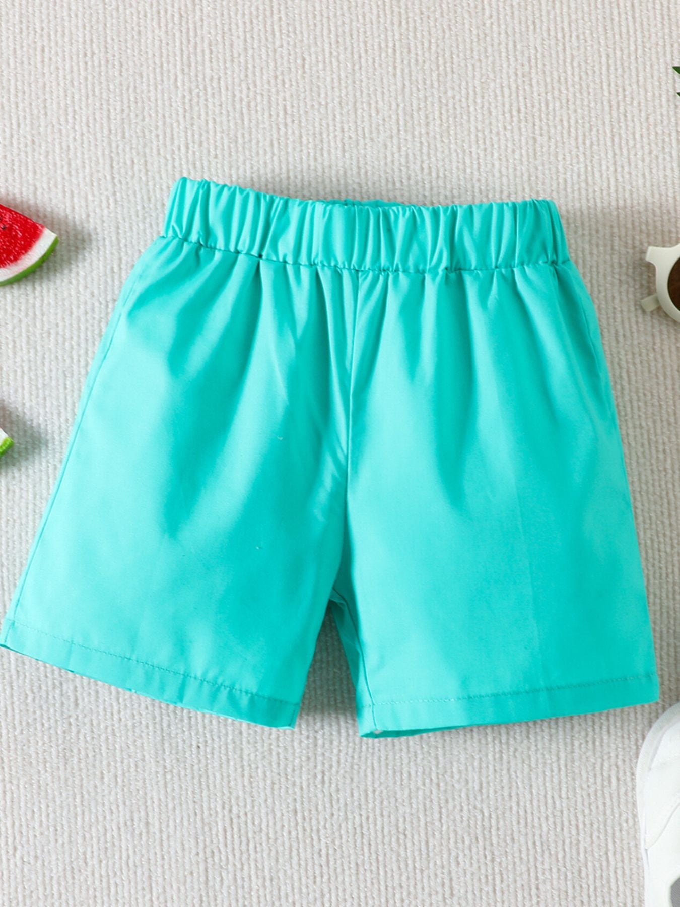 Sky blue toddler shorts with elastic waistband and tropical print accents.
