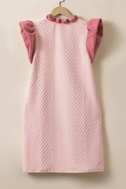Blush pink trapeze dress with textured diamond pattern, ruffle neckline and short ruffle sleeves.