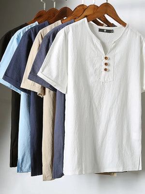 White short sleeve buttoned shirt with V-neck and wooden buttons.