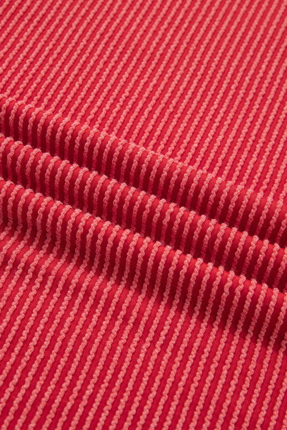 Red twisted rib t-shirt with subtle stripe texture and crew neck.