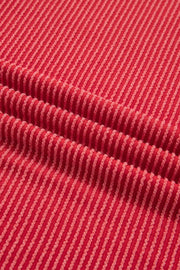 Red twisted rib t-shirt with subtle stripe texture and crew neck.