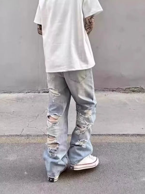 Relaxed fit light wash wide leg jeans with heavy distressing and rips.