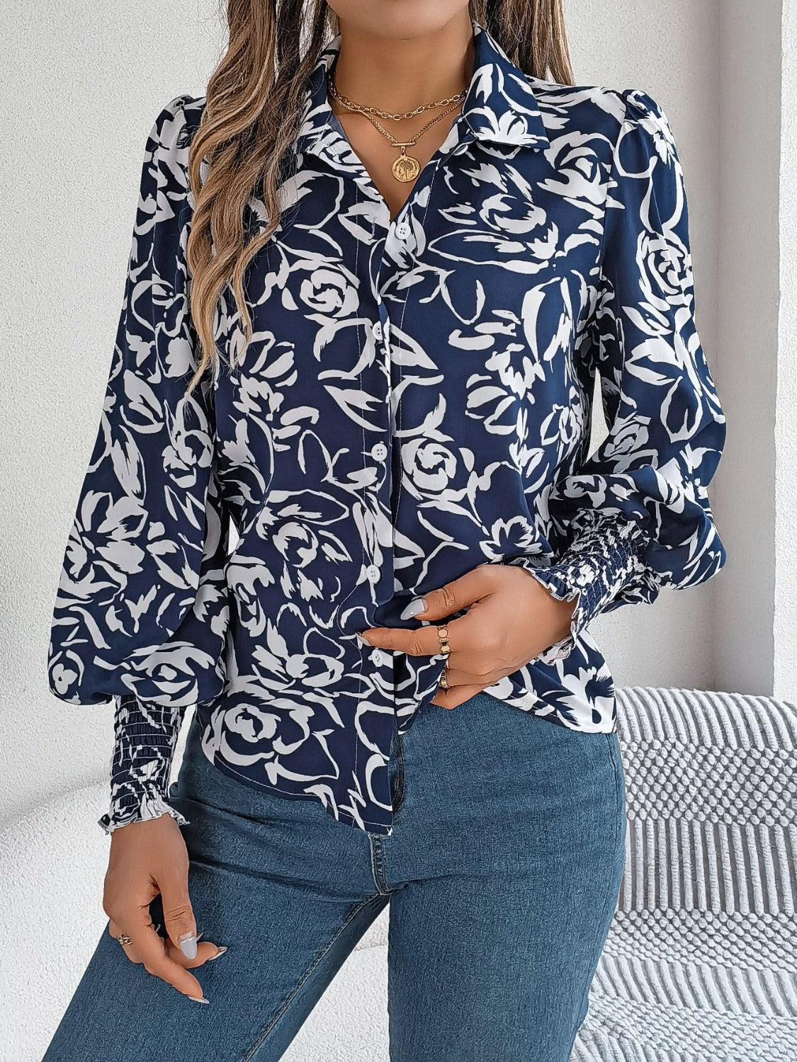 Navy floral print blouse with shirred cuffs and button front