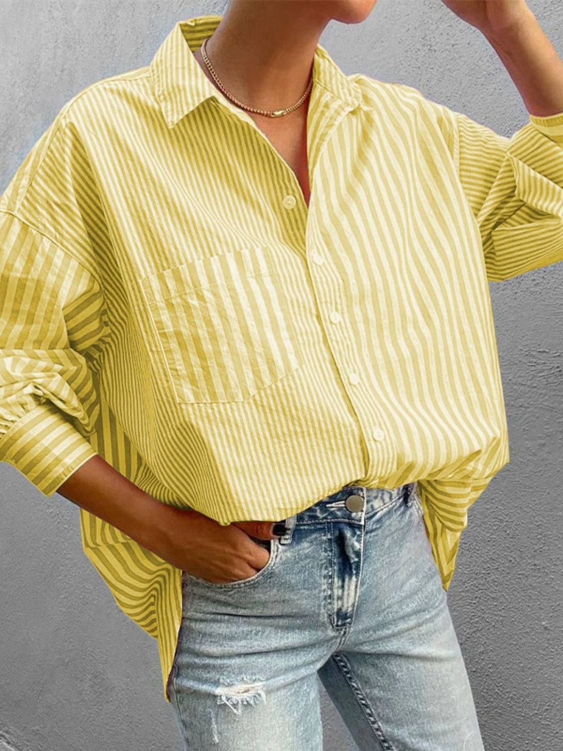 Oversized light yellow striped button-down shirt with a chest pocket and relaxed fit.