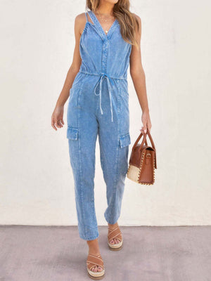 Acid wash cargo jumpsuit in medium with drawstring waist and utility pockets.