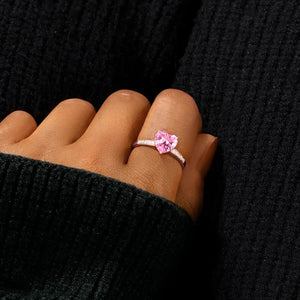 Rose gold ring with a pink heart cut pavé stone and pavé band.