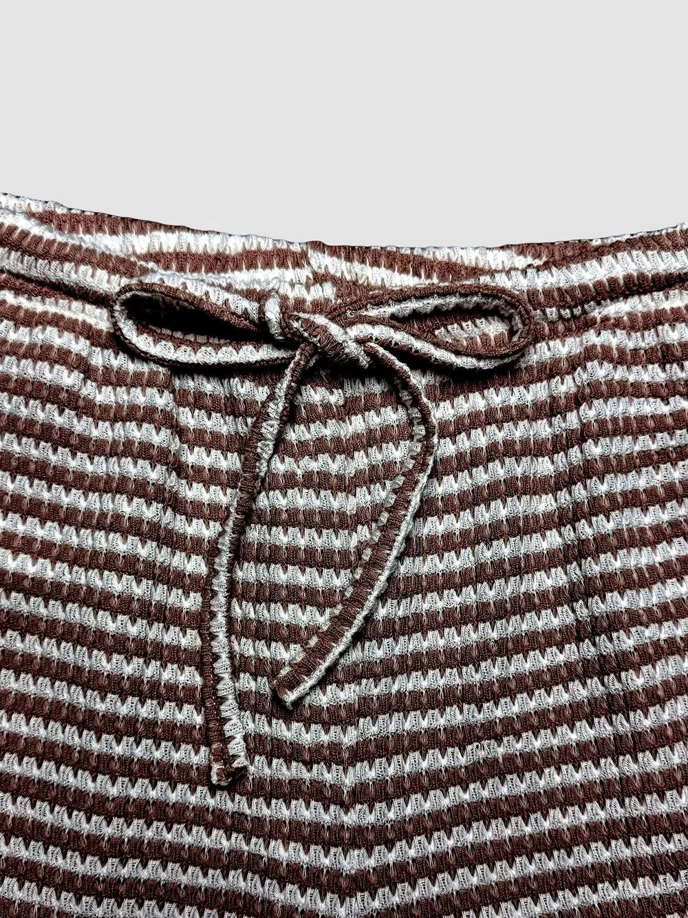 Maternity wide leg pants in dark brown and white stripe with drawstring waist.