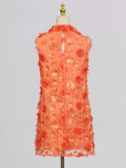 Orange floral applique mini dress with ruffled neckline and buttoned back detail.