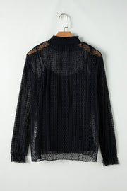 Black sheer mock neck blouse with textured dots and vertical pleats.