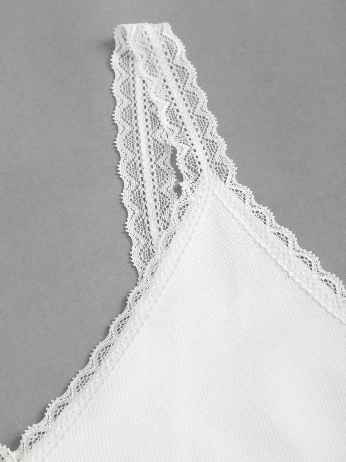 White lace trim camisole with delicate lace straps and neckline detail.