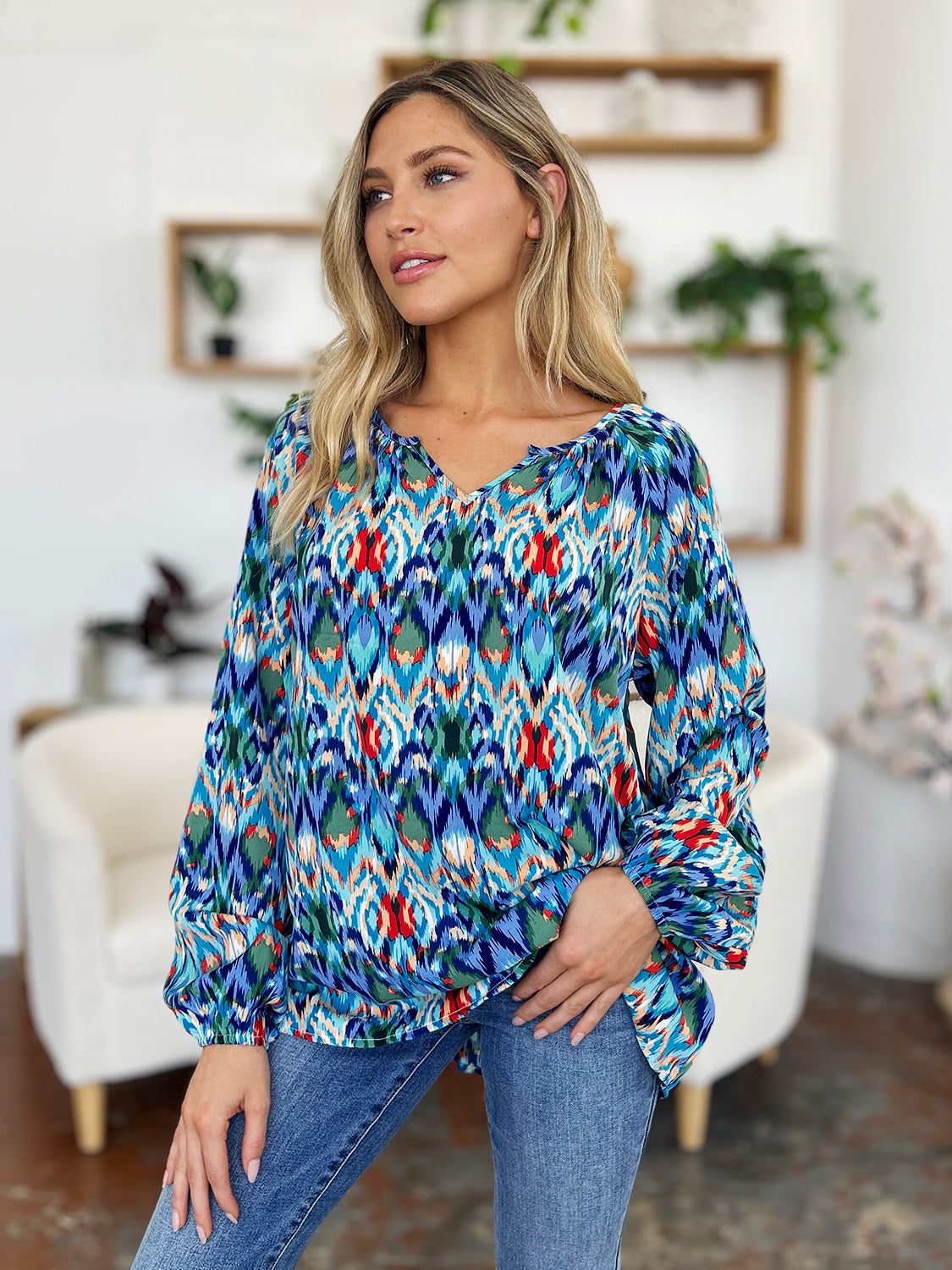 Prismatic ikat blouse with voluminous sleeves in blue and green, featuring a V-neck and relaxed fit.