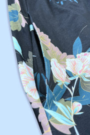Floral midi dress in black with a side pocket detail and colorful floral print.