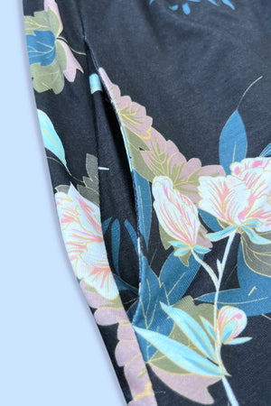 Floral midi dress in black with a side pocket detail and colorful floral print.