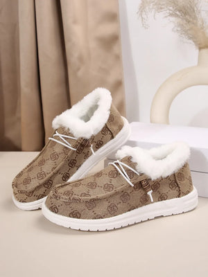 Taupe Southwestern print faux fur lined loafers with white laces and white soles.