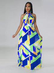 Halter neck maxi dress with bold geometric print, defined waistband, and pleated skirt.