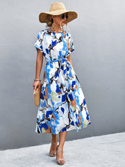 Abstract print midi dress with tie waist in blue and orange-red.