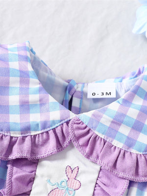 Baby one-piece with pink and purple gingham, ruffle collar, and embroidered bunny detail.