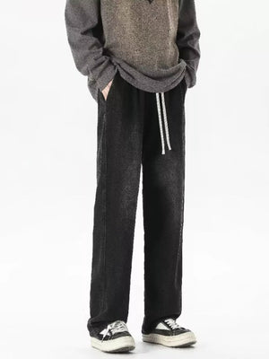 Men's relaxed fit jeans in gradient wash black with drawstring waist and pockets.
