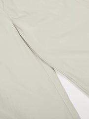 Men's light gray wide-leg sweatpants detail showing crinkled fabric and seam.