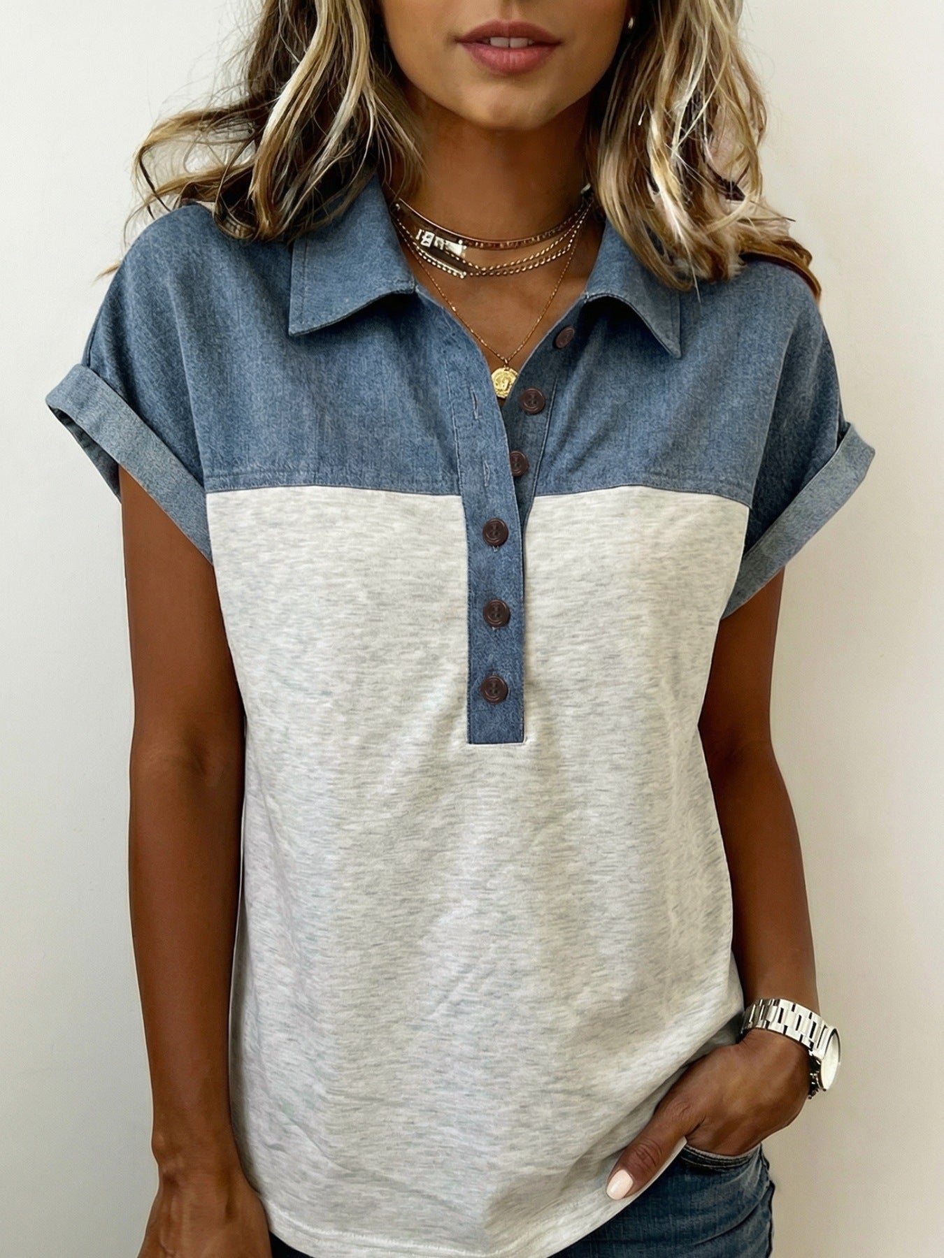Two-tone denim polo shirt with button-down collar and short sleeves.