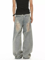 Relaxed fit vintage wash jeans in blue denim with distressed details and a baggy cut.