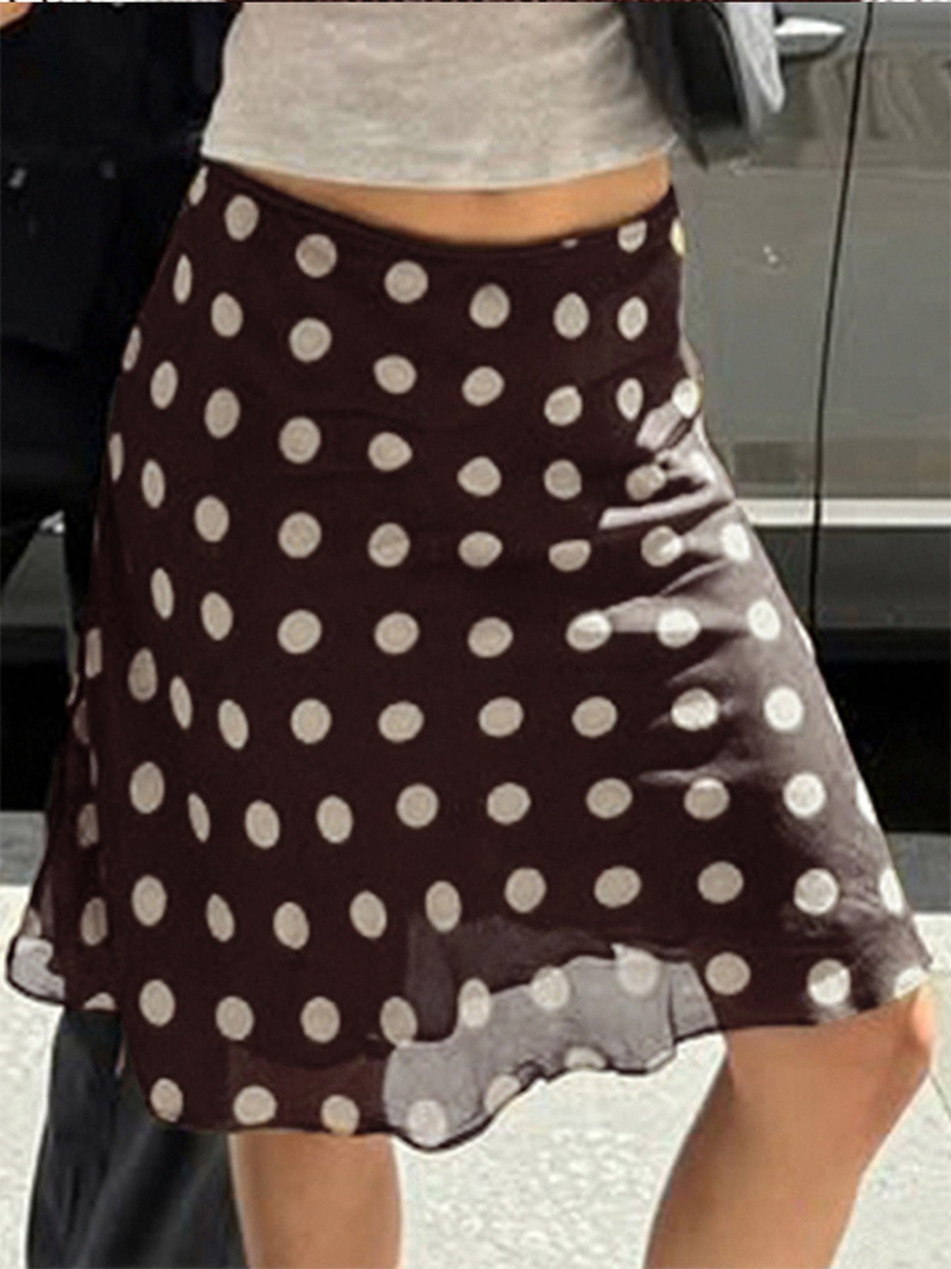 A-line mesh polka dot skirt in brown with white dots, featuring a sheer hem.