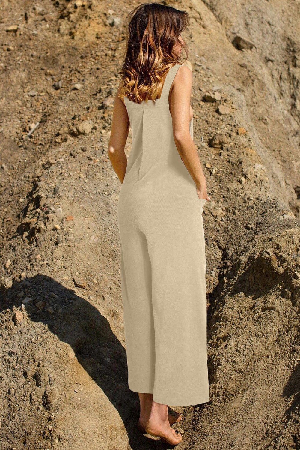 Tan corduroy overalls with wide legs and pockets, shown from the back.
