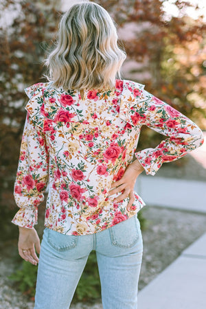 Multicolor floral ruffle smocked yoke blouse with long sleeves and ruffled cuffs.