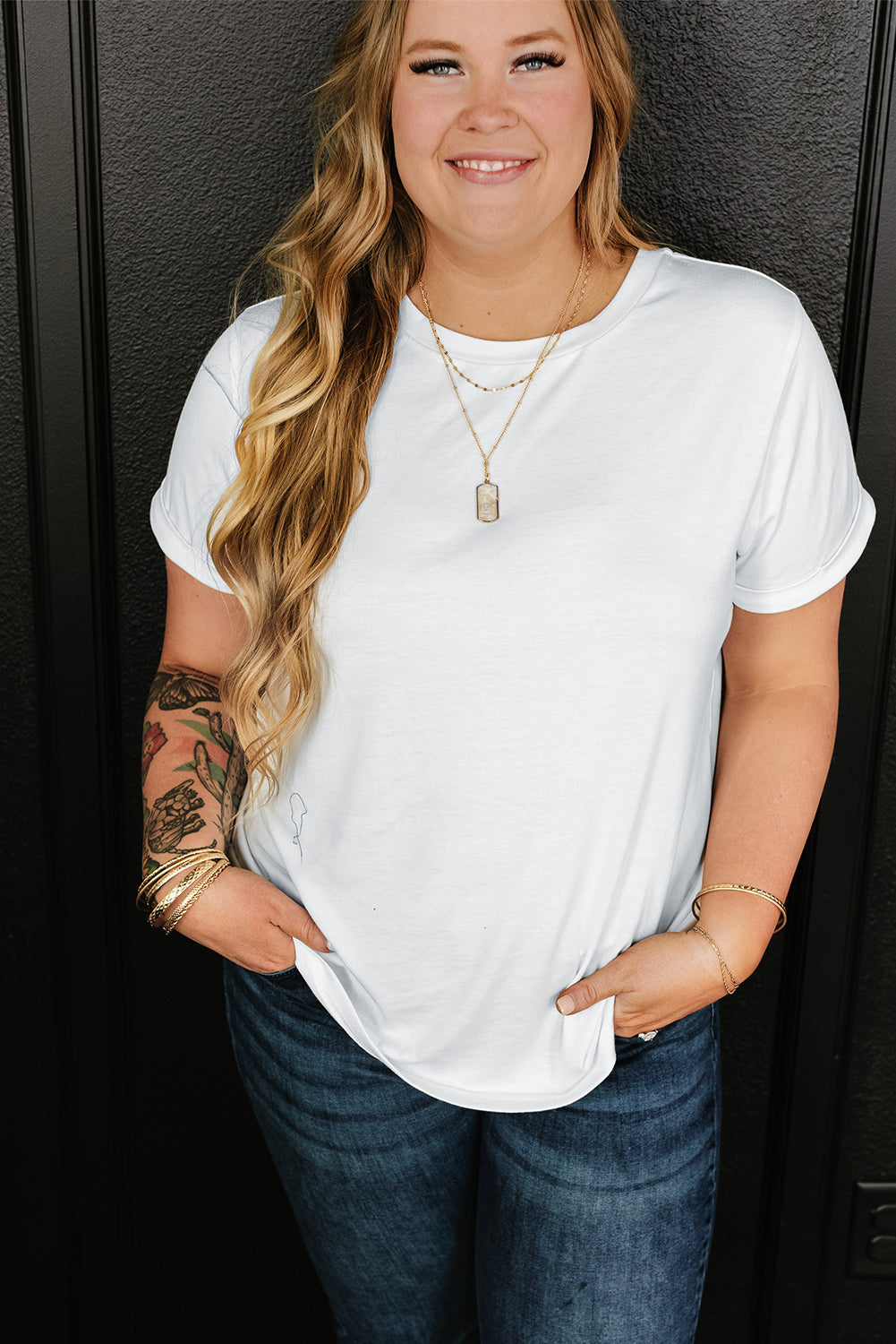 White cotton crewneck t-shirt with cuffed sleeves and a relaxed fit.