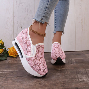 Pink floral lace slip-on sneakers with a chunky white sole and a gold ankle chain.