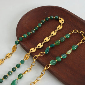 Green beaded necklace with gold chain and oval links