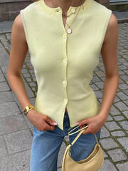 Yellow knit vest with button front and crew neck, sleeveless.