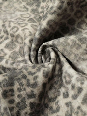Men's grey leopard print sweatpants with distressed detailing and flap pockets.