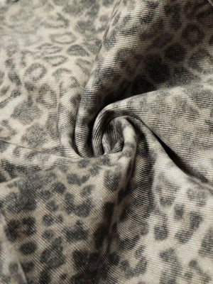 Men's grey leopard print sweatpants with distressed detailing and flap pockets.