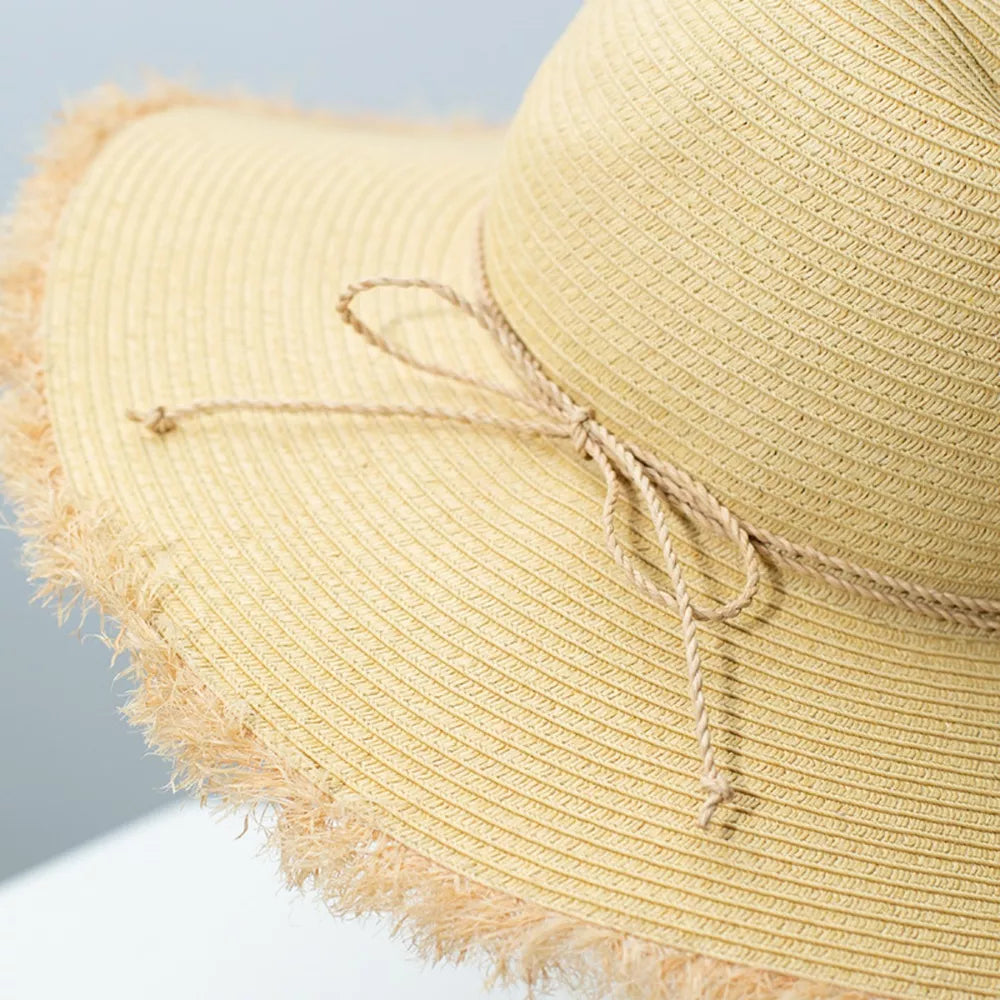 Beige straw sun hat with frayed brim and tie detail