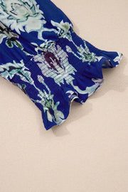 Vibrant floral maxi dress with smocked cuffs and frilled hem detail.