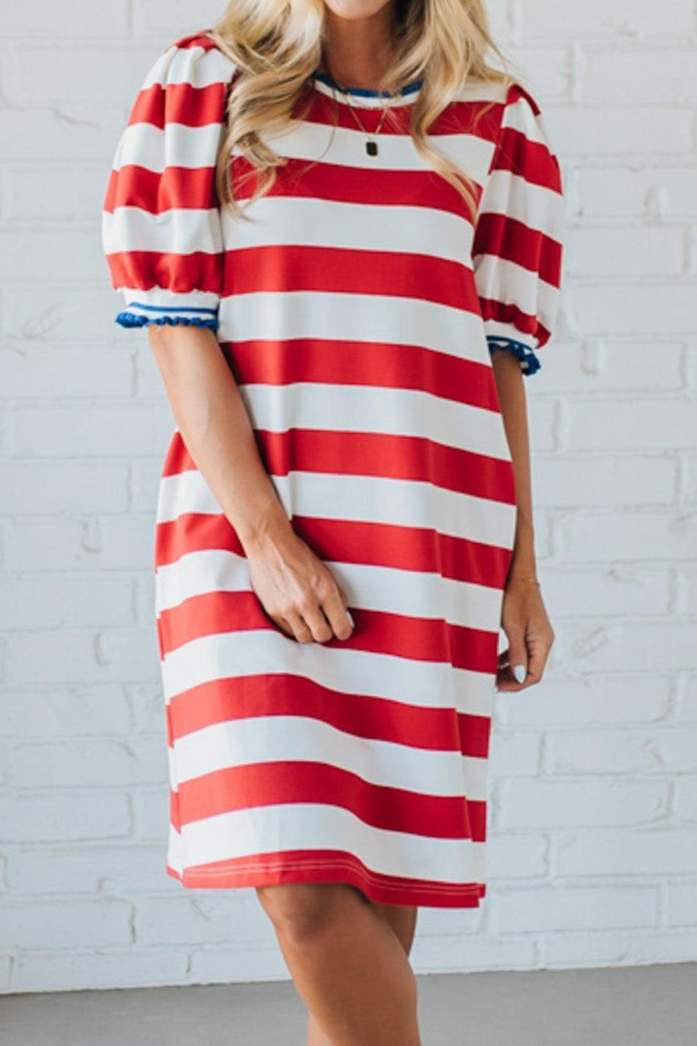Striped puff sleeve mini dress with blue trim neckline and cuffs.