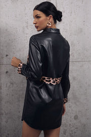 Black faux leather shirt dress with leopard print panels at waist and cuffs.