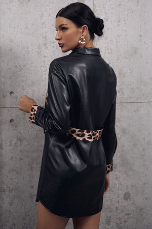 Black faux leather shirt dress with leopard print panels at waist and cuffs.