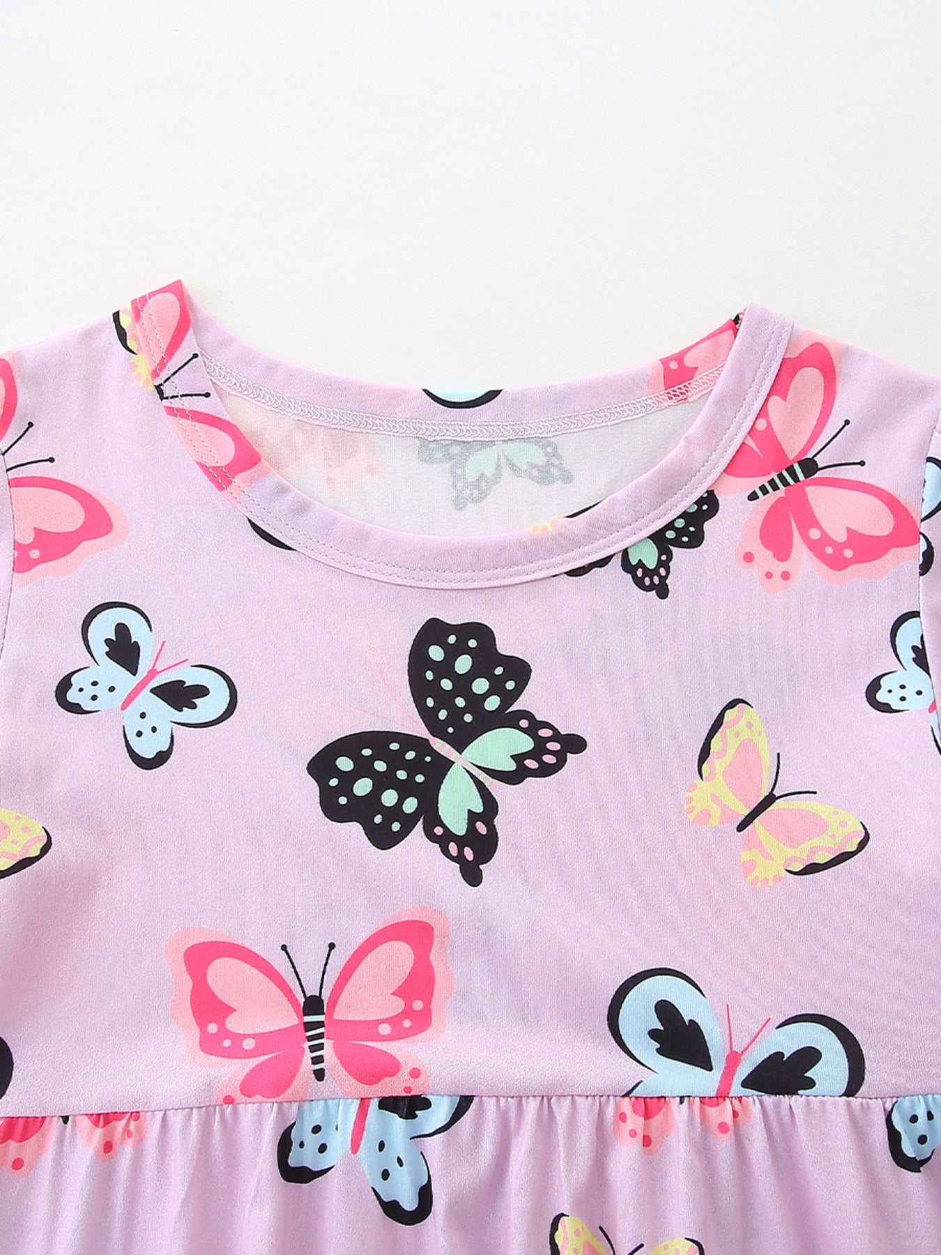Toddler dress with colorful butterfly print, crew neck, short sleeves, and ruffled hem.