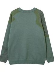 Men's green contrast knit sweater with abstract textured details and ribbed cuffs.